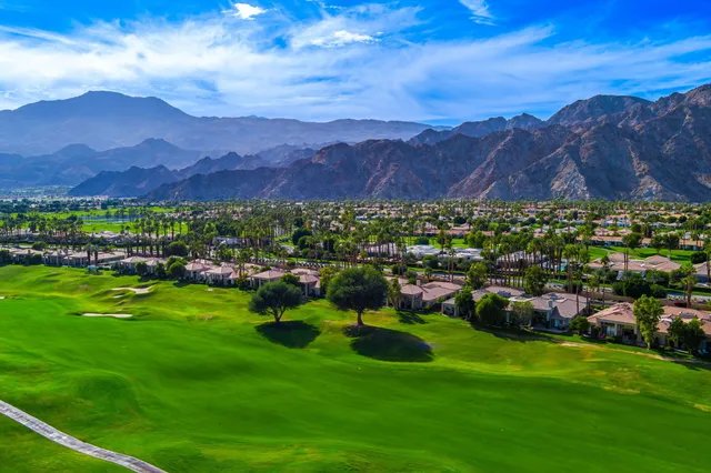 a view of a lush green hillside and houses
