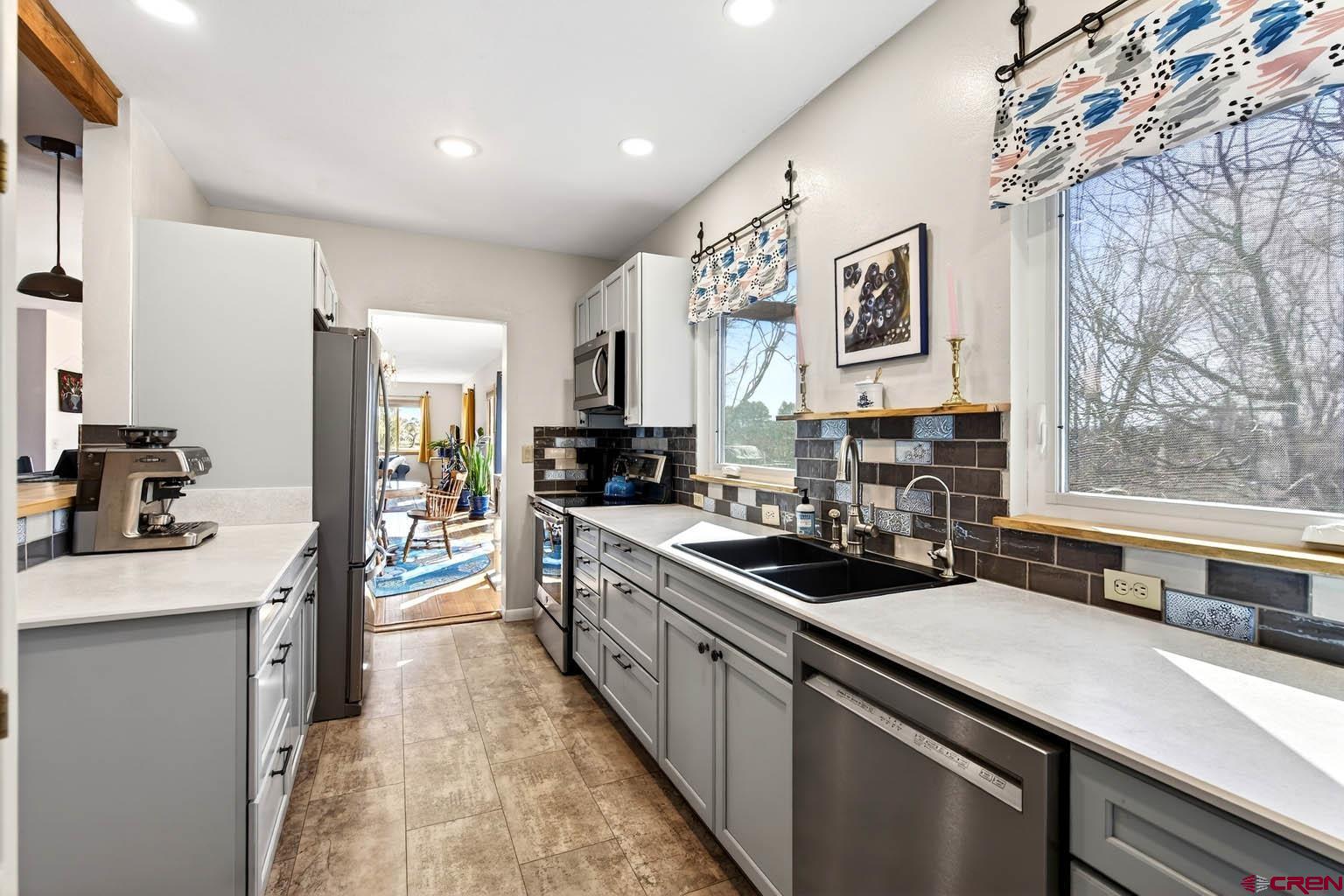 23360 Rd T Dolores, CO 81323 - Photo 11 of 45 a kitchen with a sink stove and cabinets
