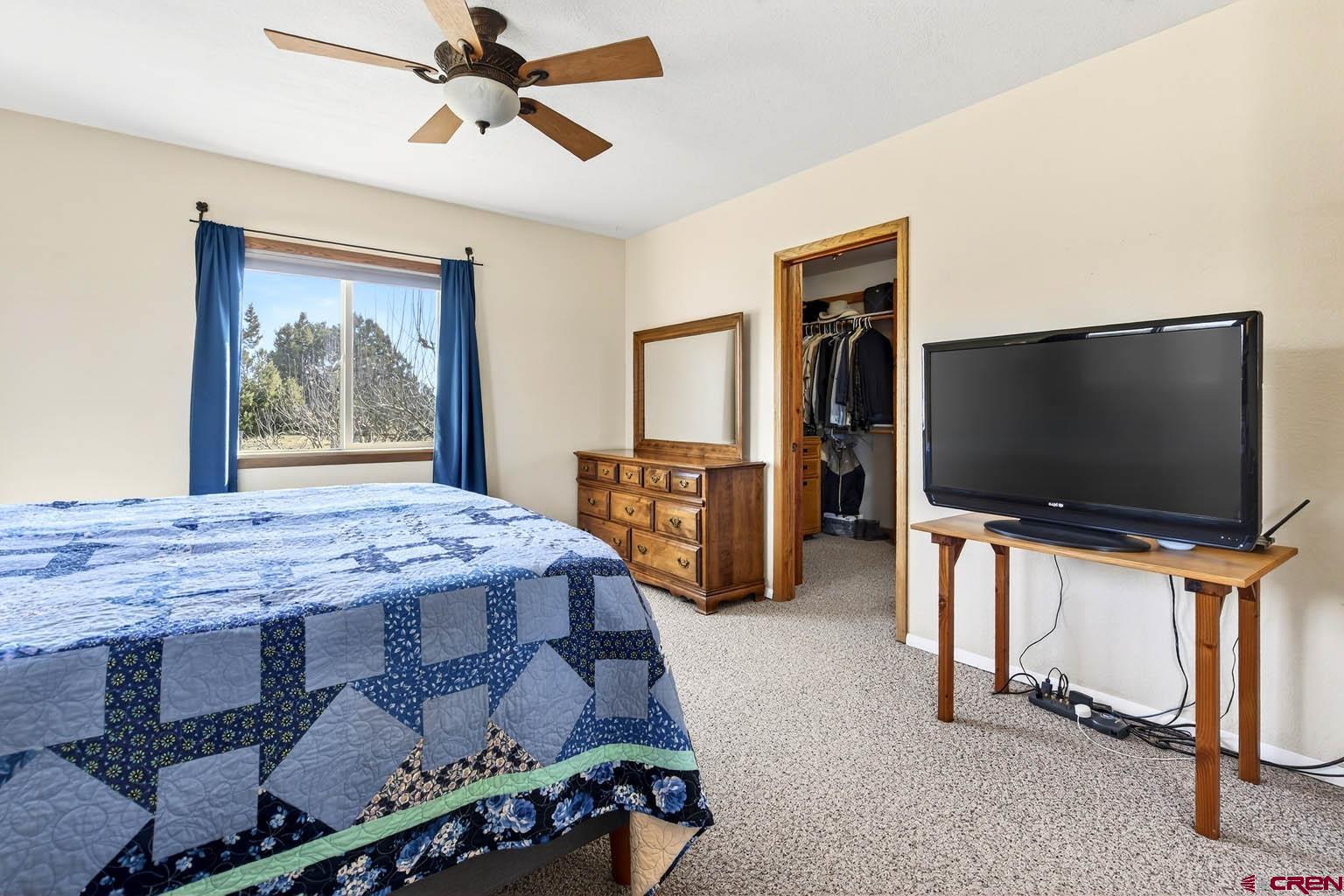 23360 Rd T Dolores, CO 81323 - Photo 14 of 45 a bedroom with a bed and a flat screen tv