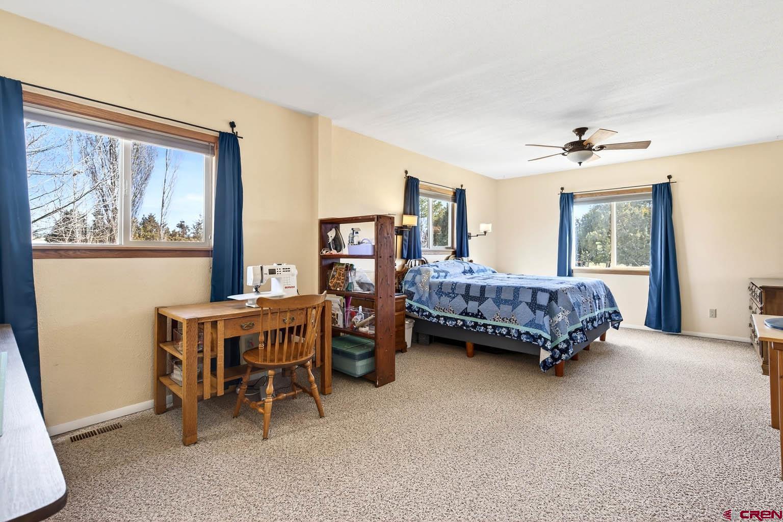 23360 Rd T Dolores, CO 81323 - Photo 15 of 45 a bedroom with a bed and a chandelier