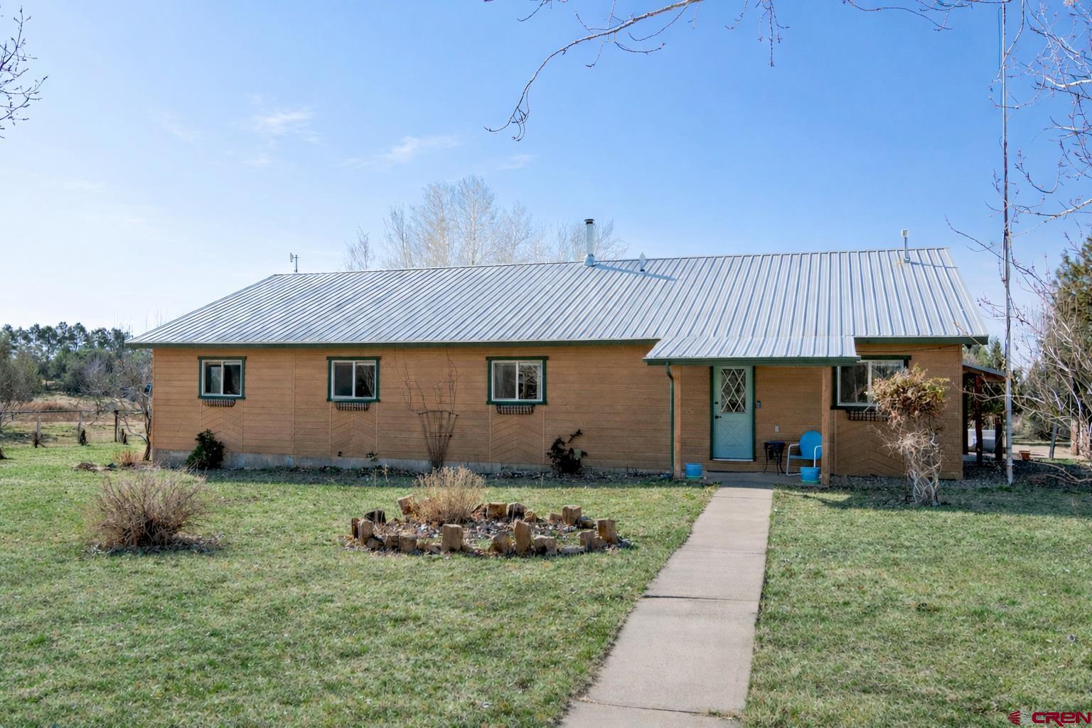 23360 Rd T Dolores, CO 81323 - Photo 2 of 45 a front view of a house with garden