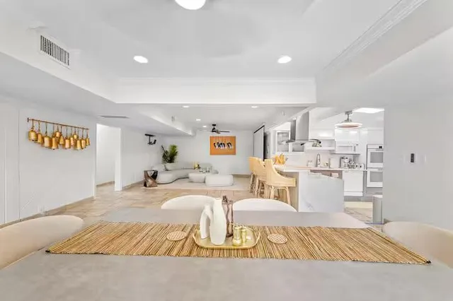a living room with furniture a rug and white walls