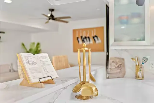 a bathroom with a granite countertop sink a toilet and a mirror