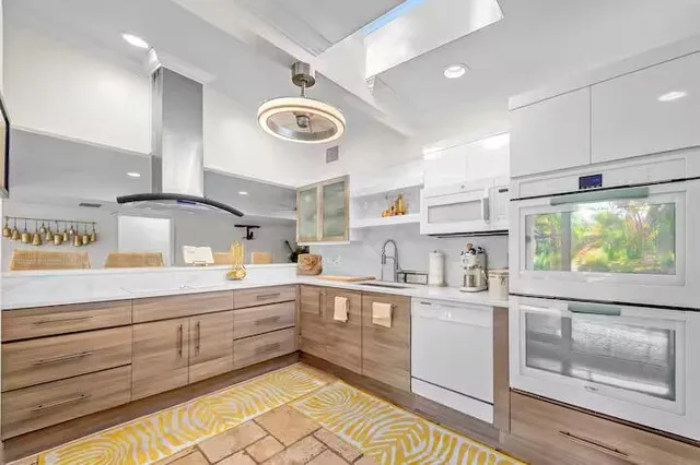 a bathroom with a granite countertop sink a toilet and a mirror