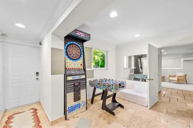 a bedroom with a large bed and a potted plant