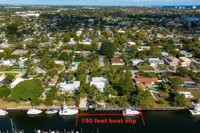 an aerial view of residential houses with outdoor space and street view