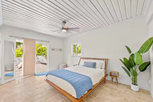 a bedroom with a bed and a painting on the wall