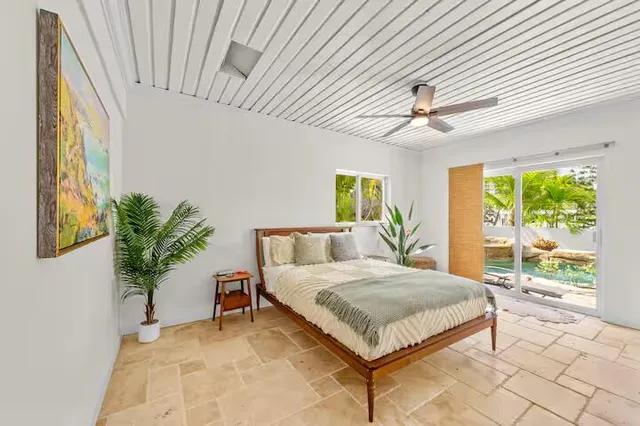 a backyard of a house with table and chairs