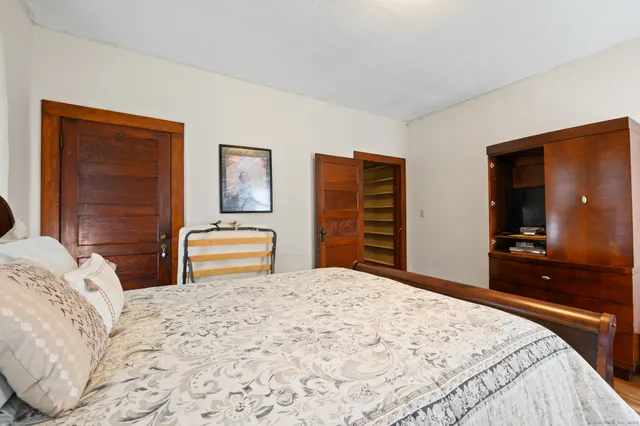 a bedroom with a bed and a dresser