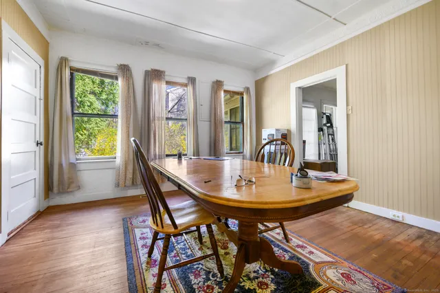 a dining room with furniture and wooden floor