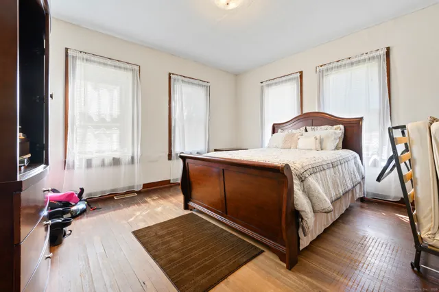 a bedroom with a bed and a potted plant