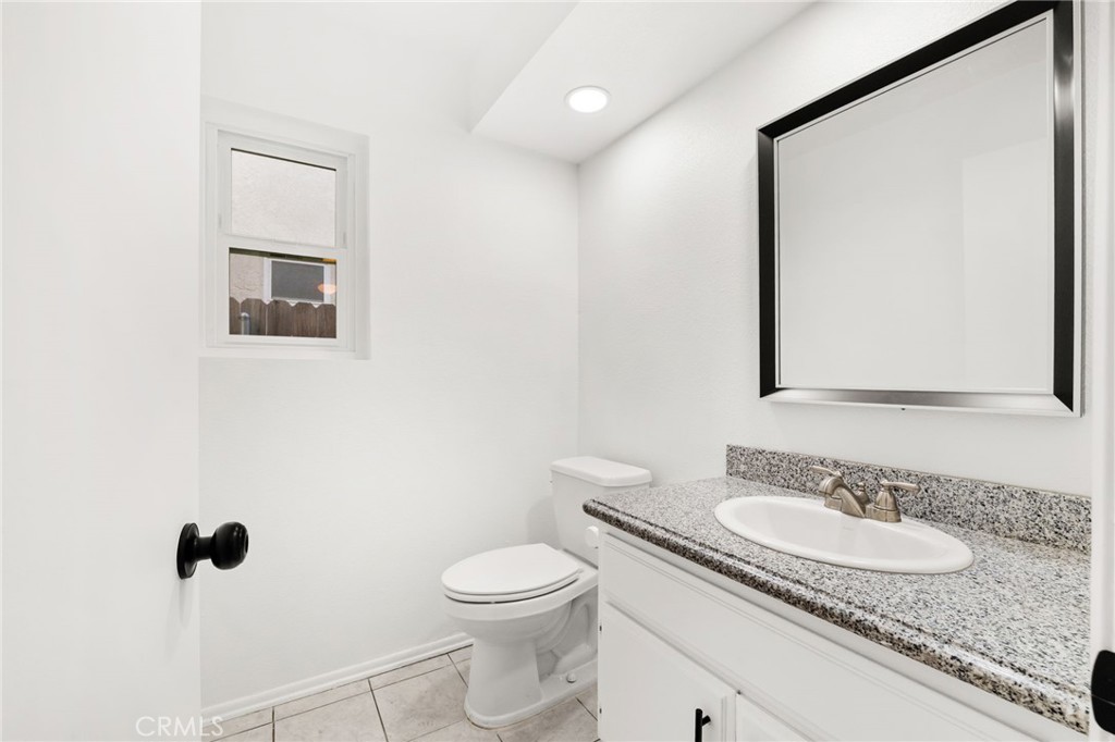 8985 Sage Drive Rancho Cucamonga, CA 91701 - Photo 13 of 49 First floor bathroom is large and spacious and features granite countertops and a framed mirror.