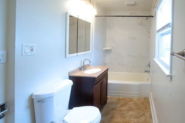 a bathroom with a sink toilet and shower