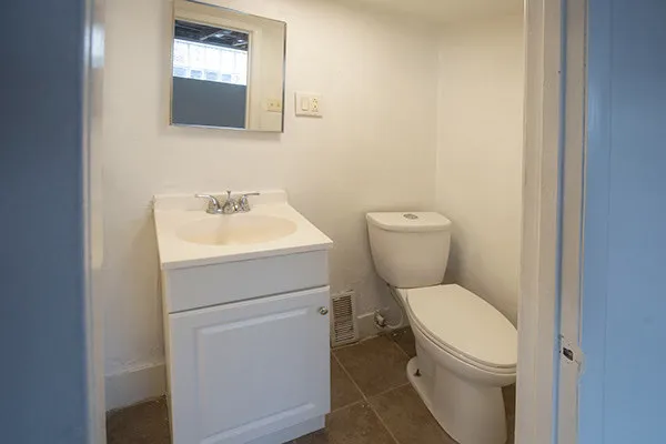 a white toilet sitting next to a bathroom sink