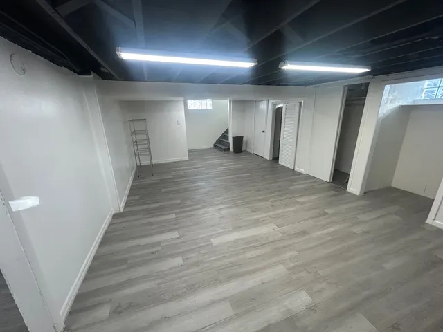 a view of a hallway with wooden floor