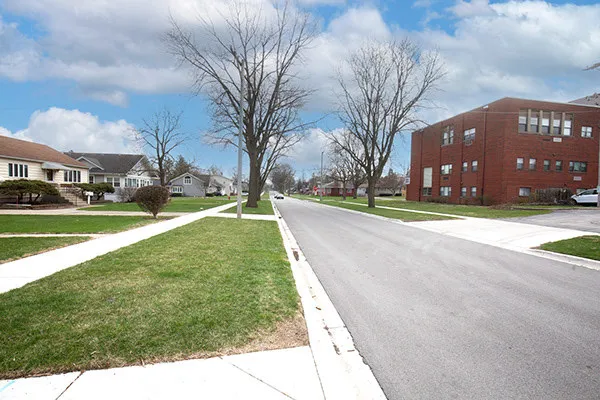 a view of a street with a building and a street sign