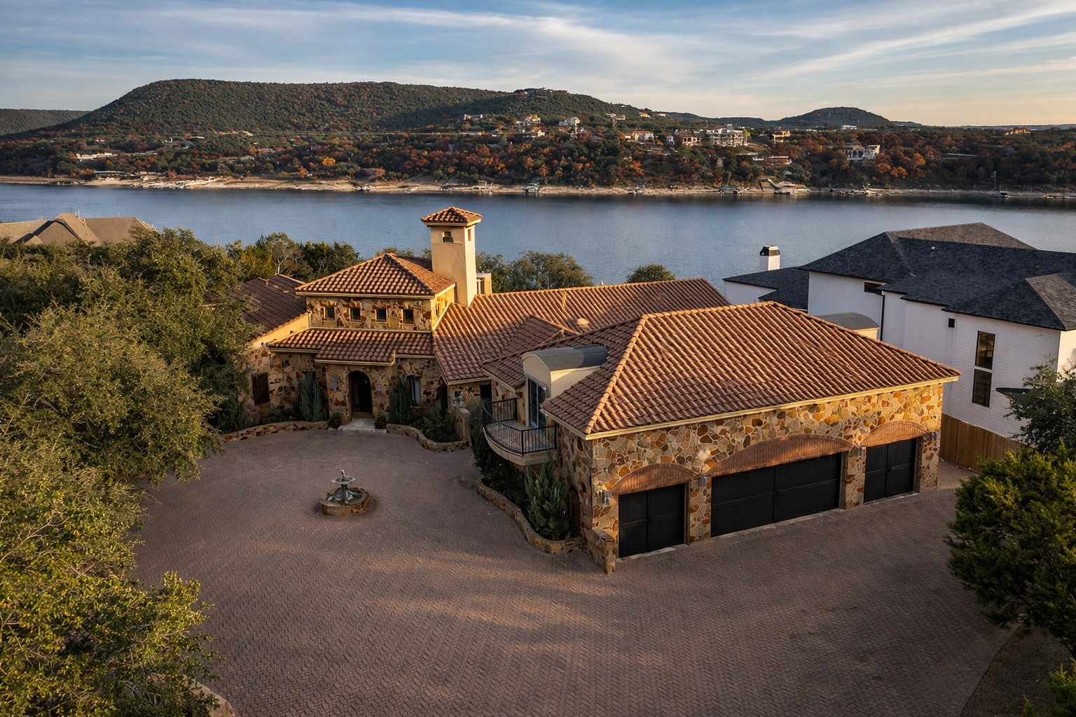 an aerial view of a houses with a lake view
