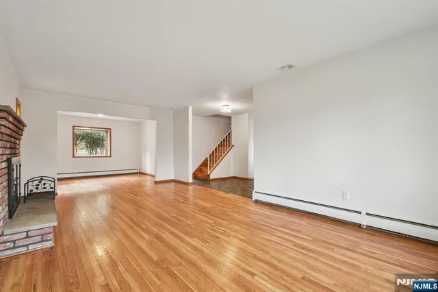 an empty room with windows and closet