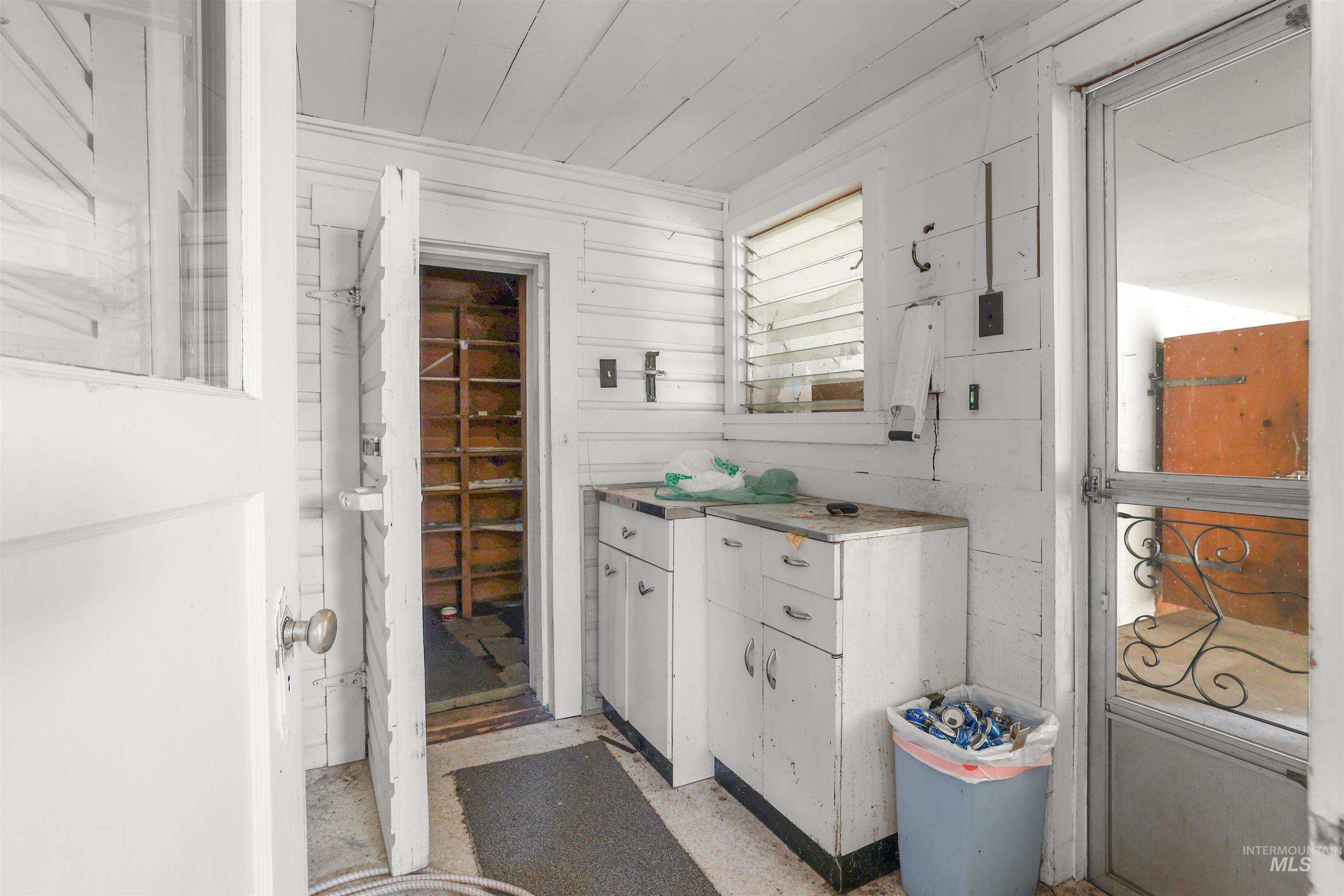 216 Ulmer Road Kooskia, ID 83539 - Photo 20 of 49 Bathroom with vanity, wood walls, and wooden ceiling