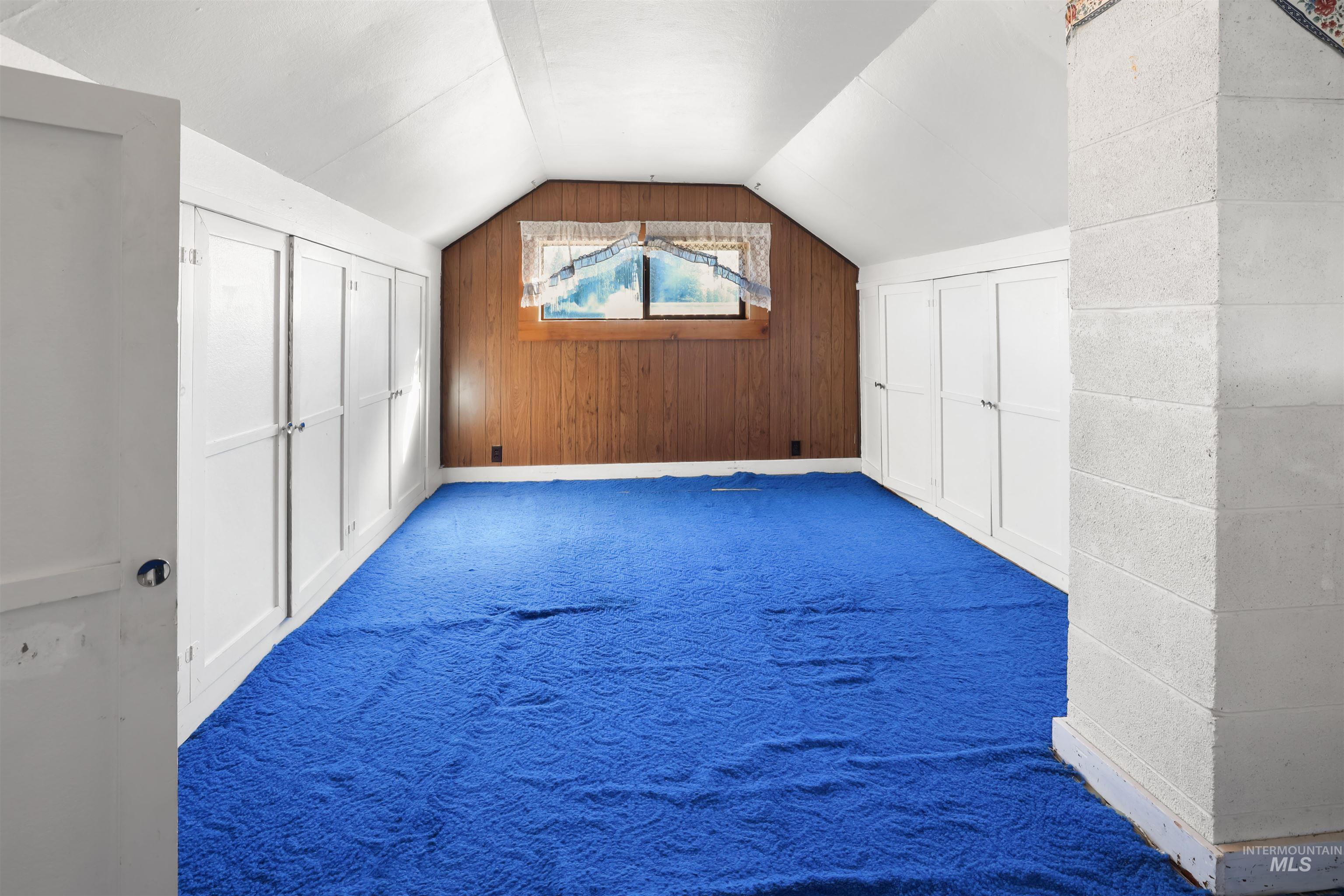 216 Ulmer Road Kooskia, ID 83539 - Photo 24 of 49 Additional living space with carpet flooring and wood walls