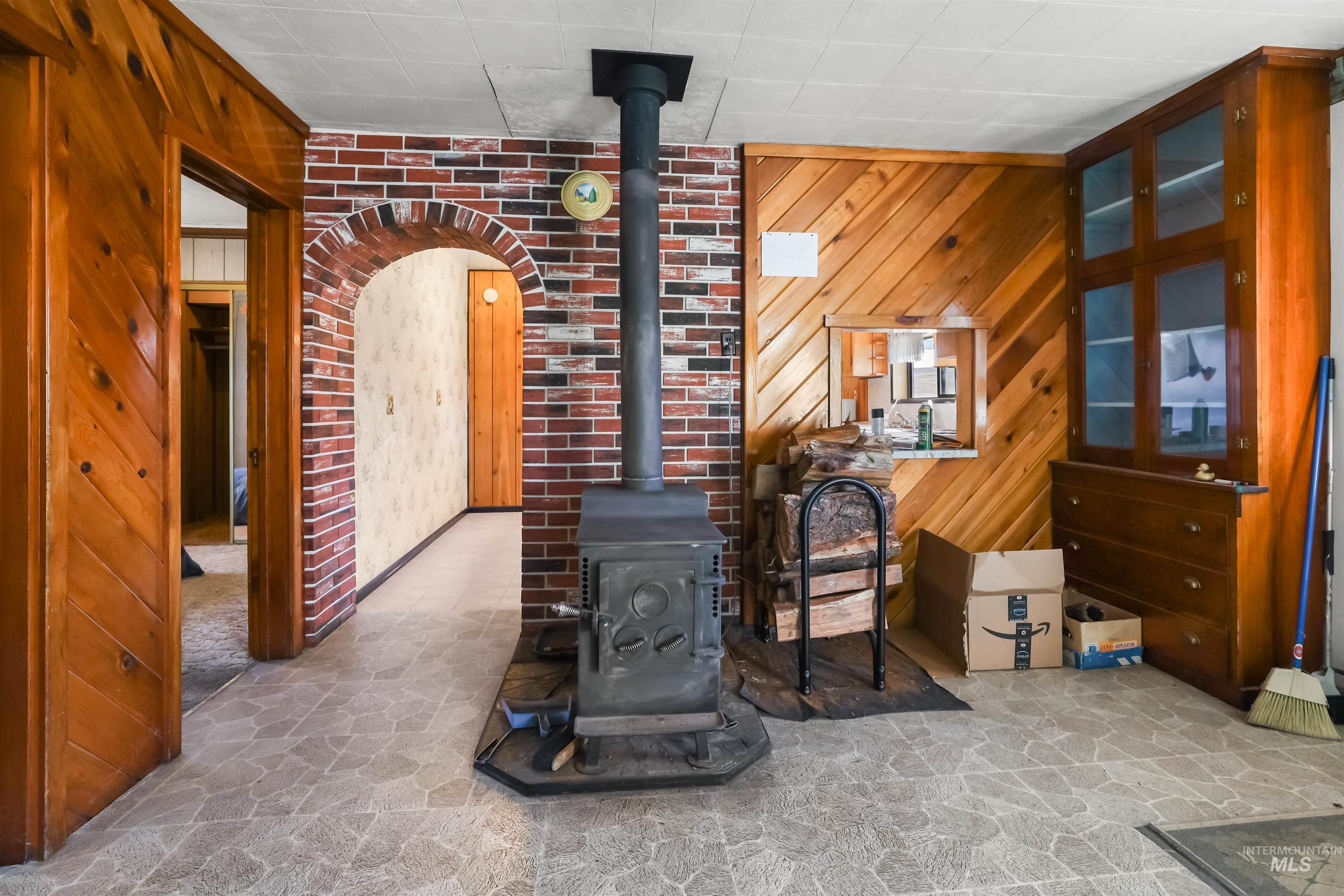 216 Ulmer Road Kooskia, ID 83539 - Photo 25 of 48 Living room featuring stone floors and wood walls
