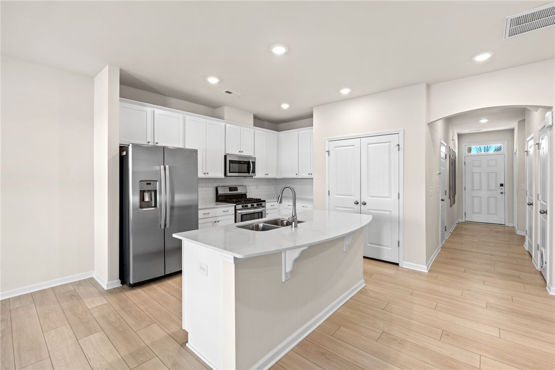 452 Bee Cv Way Pendleton, SC 29670 - Photo 14 of 37 This bright kitchen features an island, ample counter space, and modern appliances perfect for daily living.