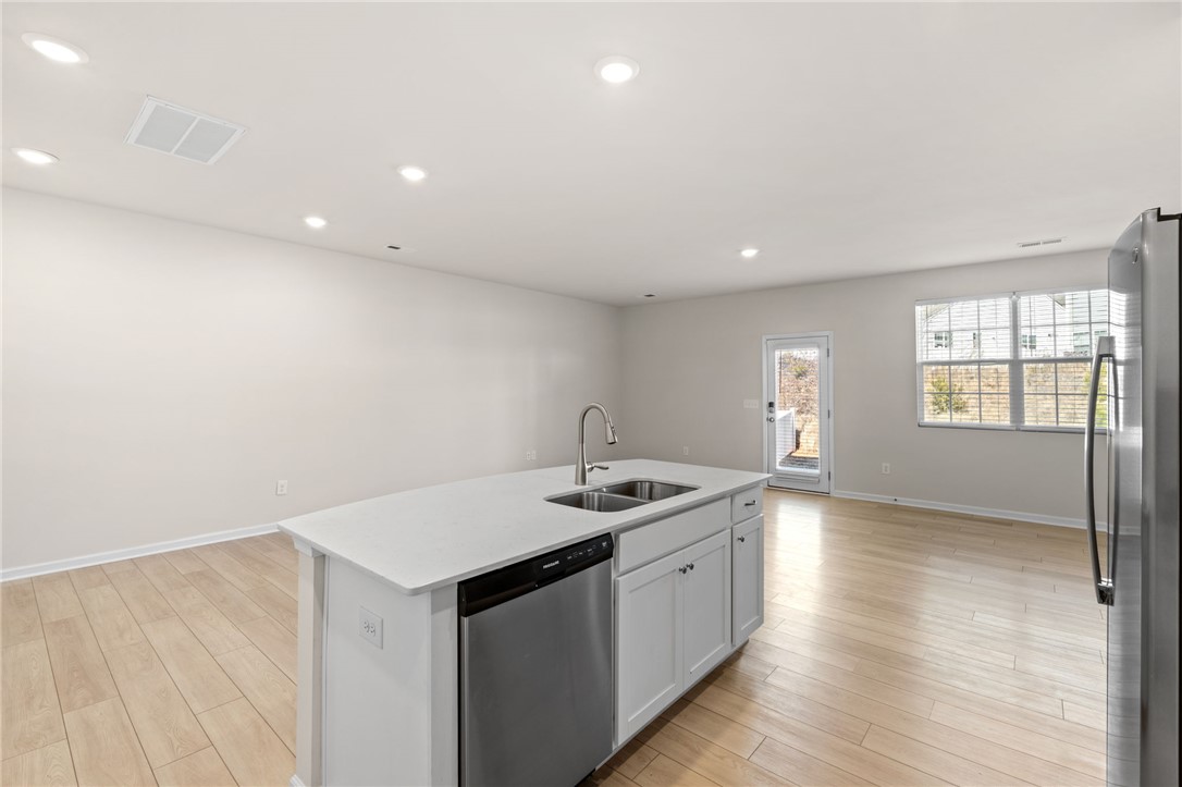 452 Bee Cv Way Pendleton, SC 29670 - Photo 15 of 37 This open concept space features a kitchen island and bright natural light.
