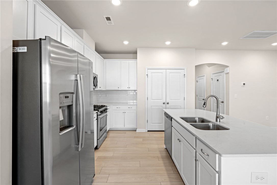 452 Bee Cv Way Pendleton, SC 29670 - Photo 16 of 37 This bright kitchen features white cabinetry and stainless steel appliances, creating a fresh and inviting atmosphere.