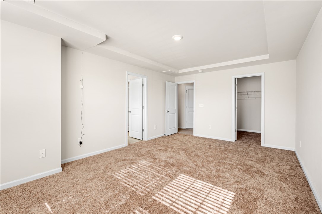 452 Bee Cv Way Pendleton, SC 29670 - Photo 22 of 37 This spacious bedroom offers comfortable carpeting and convenient access to a walk-in closet.