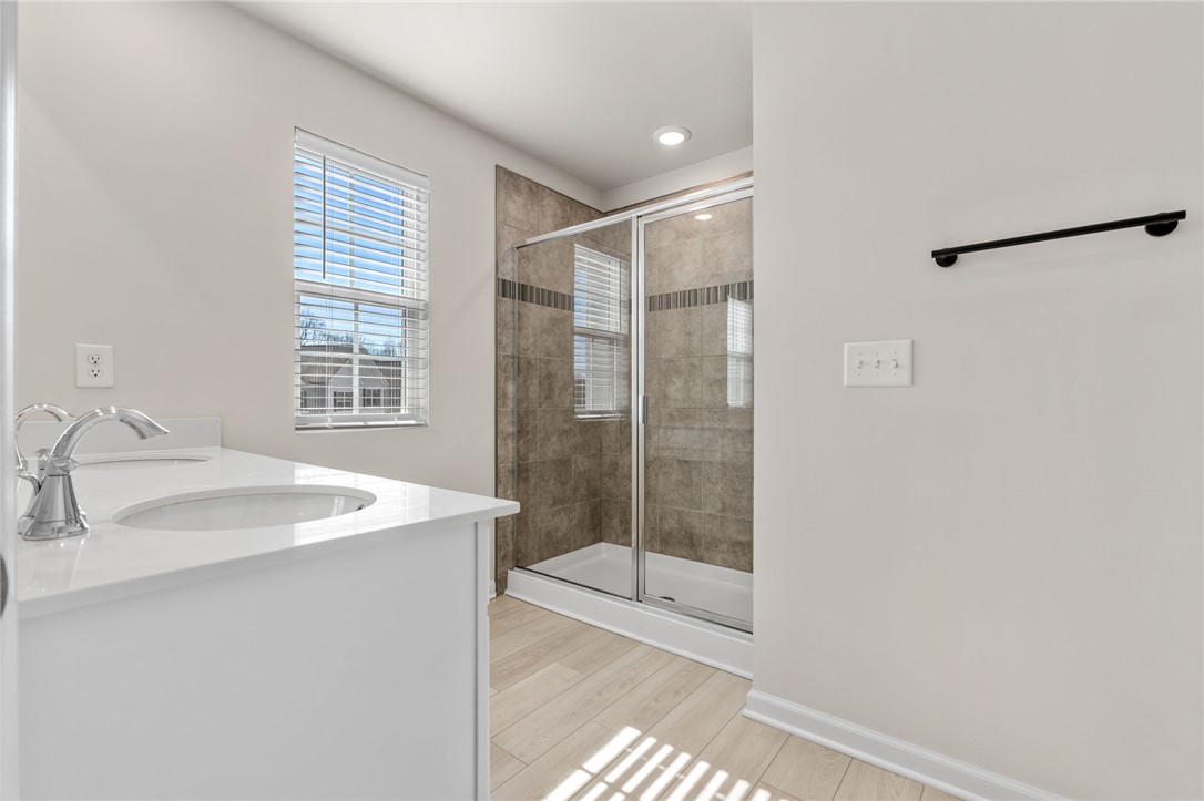 452 Bee Cv Way Pendleton, SC 29670 - Photo 25 of 37 This bright bathroom features a spacious shower and a vanity with a sleek sink.