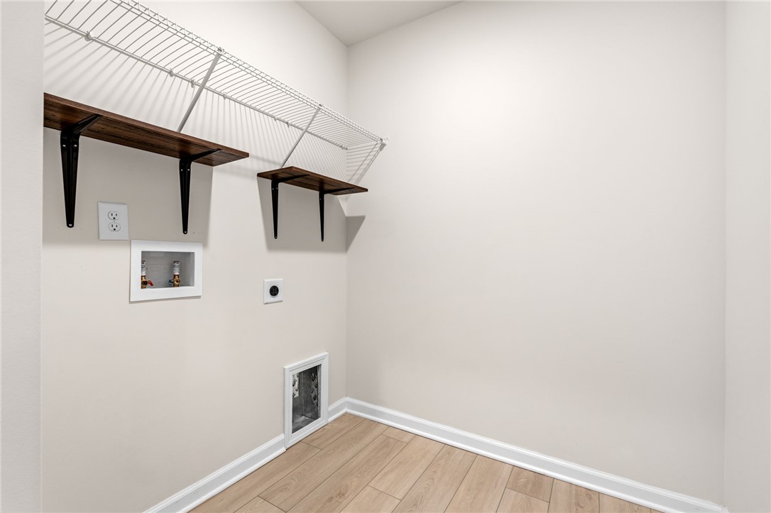 452 Bee Cv Way Pendleton, SC 29670 - Photo 26 of 37 Functional utility space featuring wood-look flooring and convenient wall-mounted shelving.