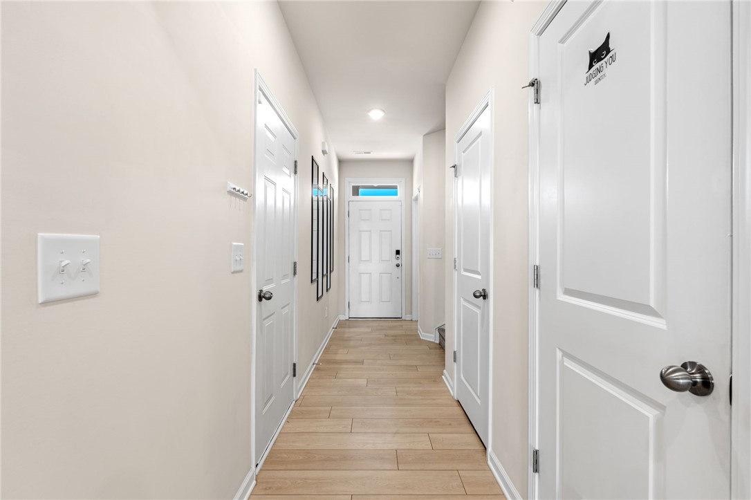 452 Bee Cv Way Pendleton, SC 29670 - Photo 5 of 37 This bright hallway showcases durable tile flooring, guiding you toward the inviting entry.
