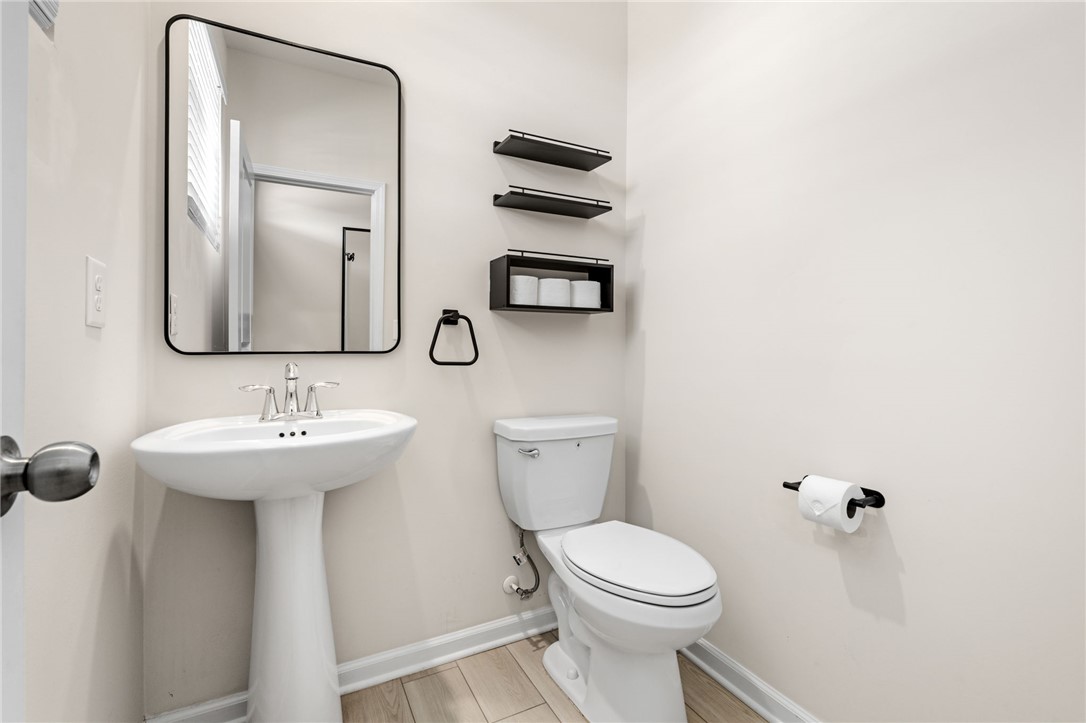 452 Bee Cv Way Pendleton, SC 29670 - Photo 6 of 37 This bright bathroom features a pedestal sink and contemporary fixtures for modern comfort.