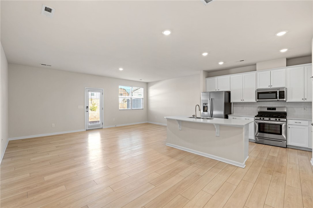 452 Bee Cv Way Pendleton, SC 29670 - Photo 7 of 37 This open concept space features a kitchen island and sleek appliances, ideal for entertaining.