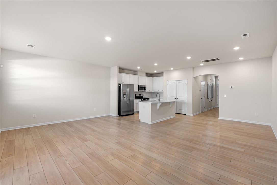 452 Bee Cv Way Pendleton, SC 29670 - Photo 9 of 37 Bright and airy open-concept living space with sleek flooring and a modern kitchen.