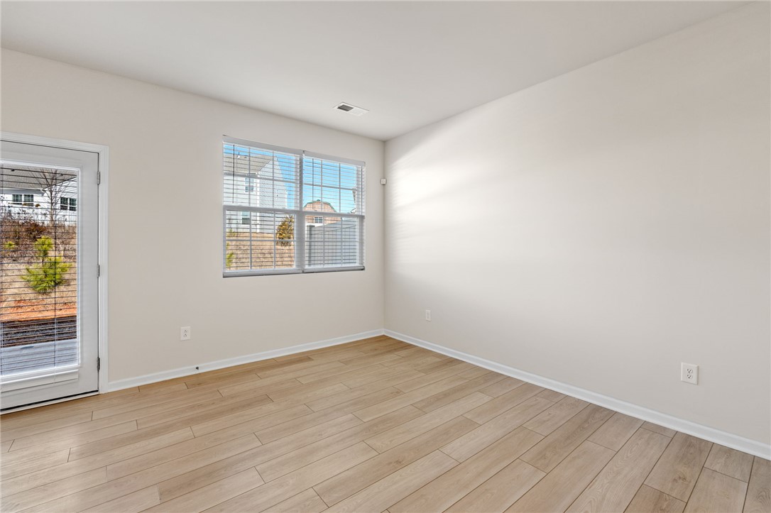 452 Bee Cv Way Pendleton, SC 29670 - Photo 10 of 37 This bright room features beautiful flooring and abundant natural light through a large window and door.