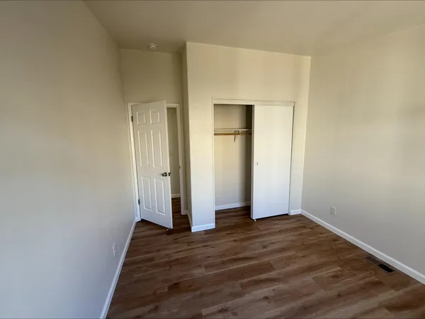 a view of a room with wooden floor