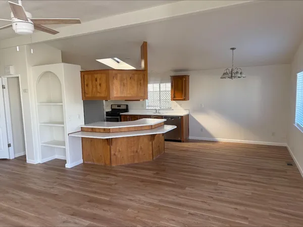 a kitchen with a sink cabinets and wooden floor