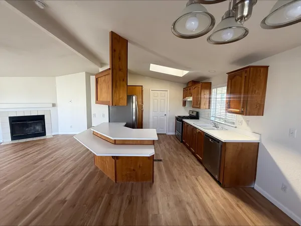 a large kitchen with stainless steel appliances kitchen island a large counter space a sink and appliances