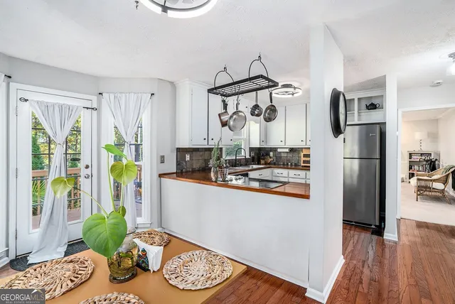 a kitchen with stainless steel appliances granite countertop a refrigerator and a stove