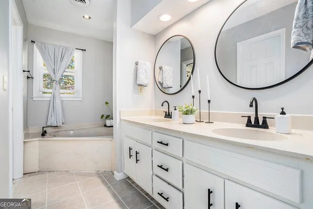 a bathroom with a sink double vanity and a mirror