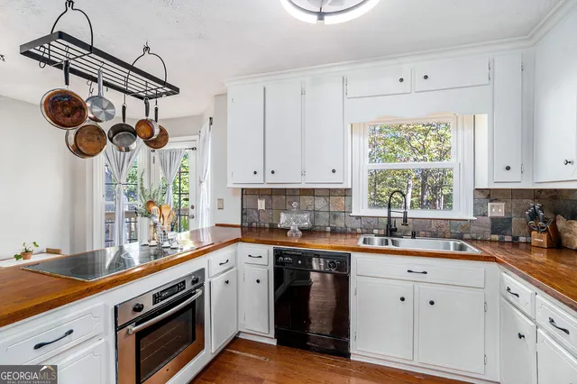 a kitchen with a sink cabinets and window