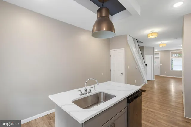 a kitchen with a sink and chandelier