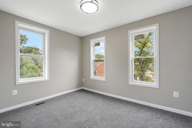 a view of an empty room with windows