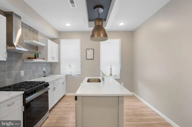 a kitchen with a sink cabinets and stainless steel appliances