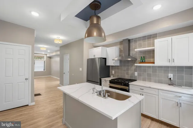 a kitchen with a sink stove and refrigerator