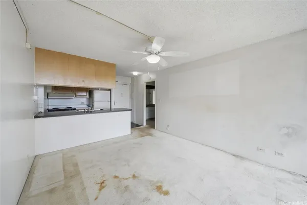 a view of a kitchen with a sink and a refrigerator