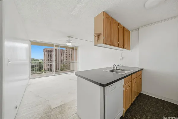 a utility room with faucet washer and a view of living room