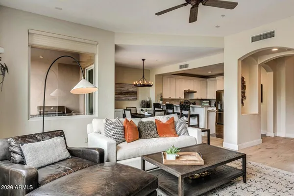 a living room with furniture and a wooden floor