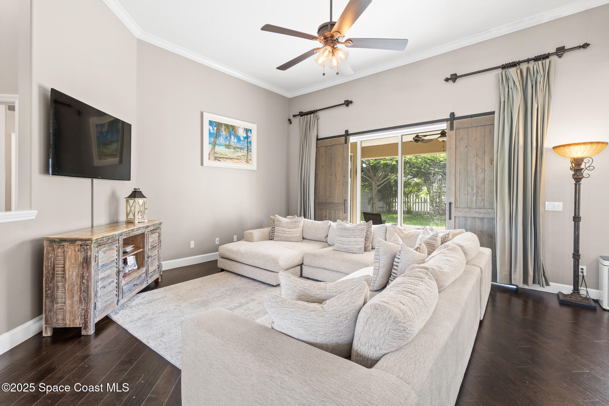 1007 Dowitcher Court Rockledge, FL 32955 - Photo 21 of 106 a living room with furniture and a flat screen tv